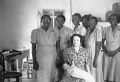 Midwives in training posing for photograph with delivery mannequin