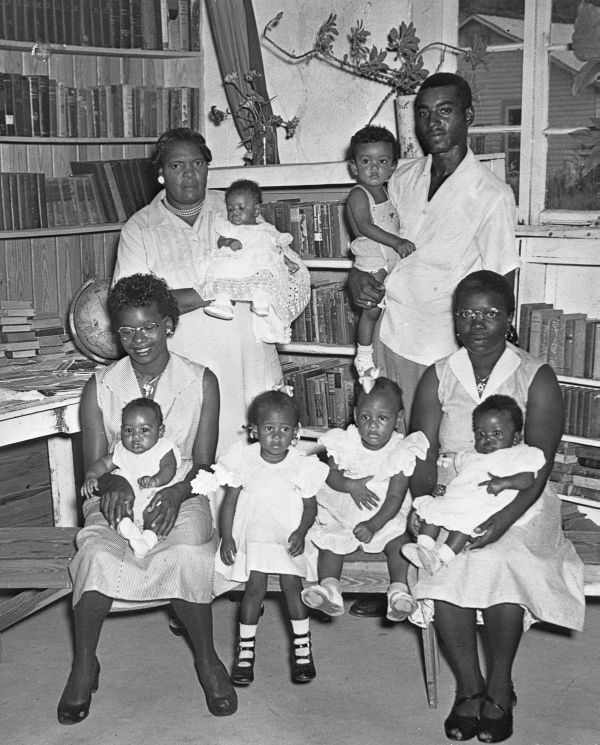 People posing for the camera inside the Minerva Monroe Library