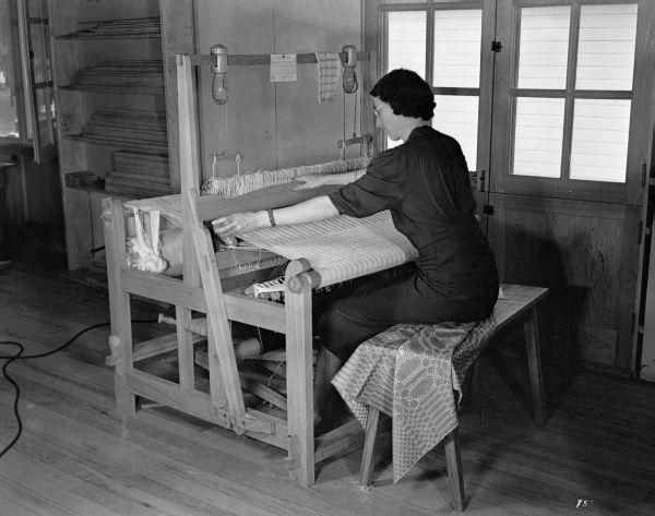 Weaving on a large loom at the WPA's Camp Roosevelt - Ocala, Florida.