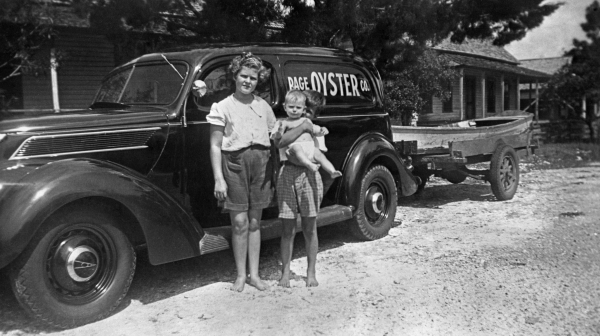 Charles Harrell with his sisters standing by their grandfather's Page Oyster Co. car in Panacea.