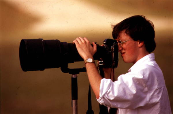 Photographer for the Tallahassee Democrat posing with camera.