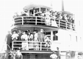 Tourists posing on the bow of the Hiawatha