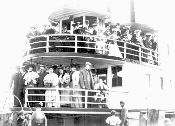Tourists posing on the bow of the Hiawatha