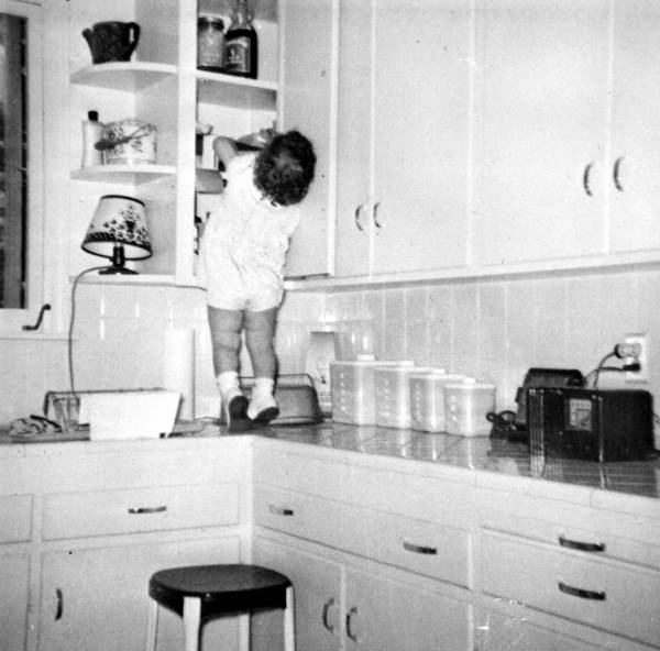 Child looking in cabinets..