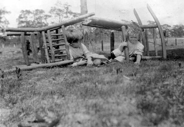 Virginia and Bub Ahern laying beneath some chairs - Babson Park, Florida
