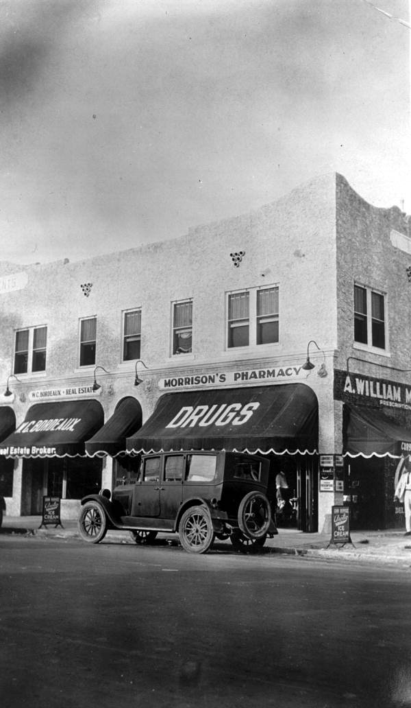 Automobile parked in front of Morrison's Pharmacy - Miami, Florida.