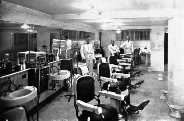 Interior view showing barbers assembled for a group photo in the Princess Martha Hotel barber shop - Saint Petersburg, Florida.