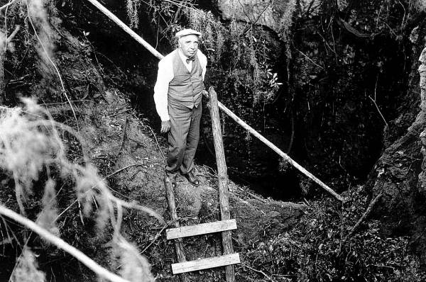 Walter Holmes looking down into entrance of Saber-Tooth Cave - Lecanto, Florida