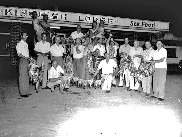 Group of men holding up their fish catch