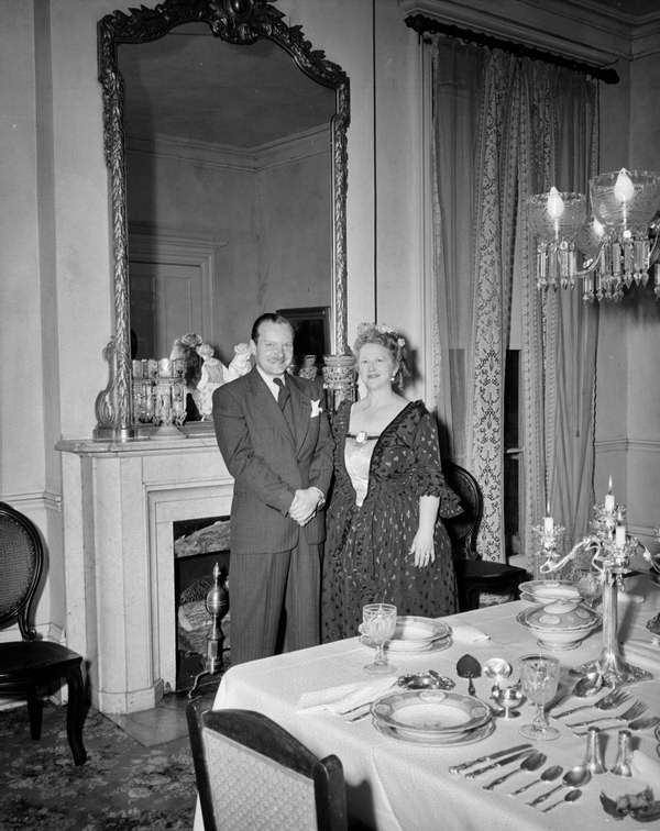 Thomas and Margaret Hood next to dining room table with tableware and silverware sets on display at Goodwood