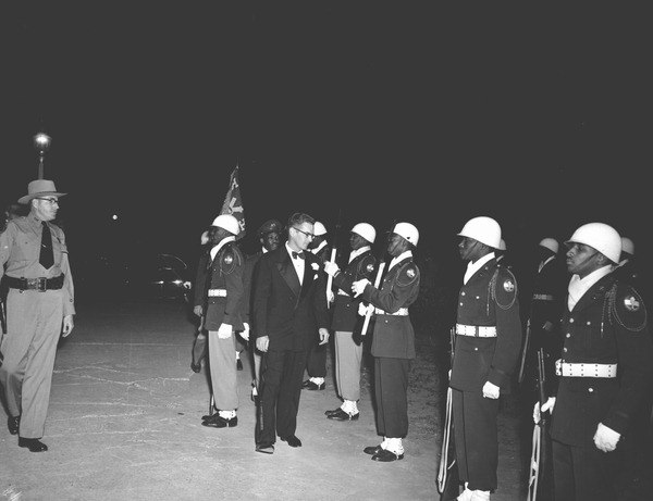 Governor Dan McCarty inspecting military group.
