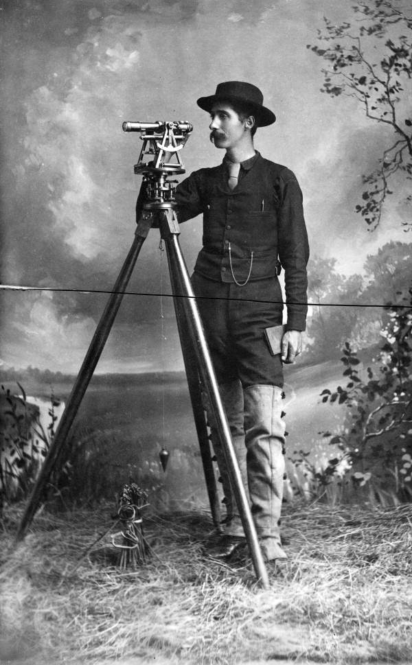 Overton Bernard with surveying equipment.