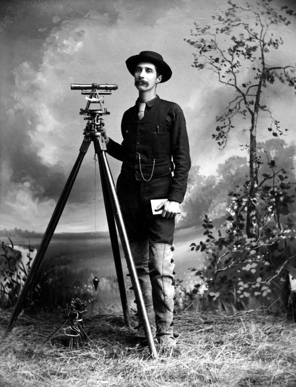 Overton Bernard with surveying equipment.