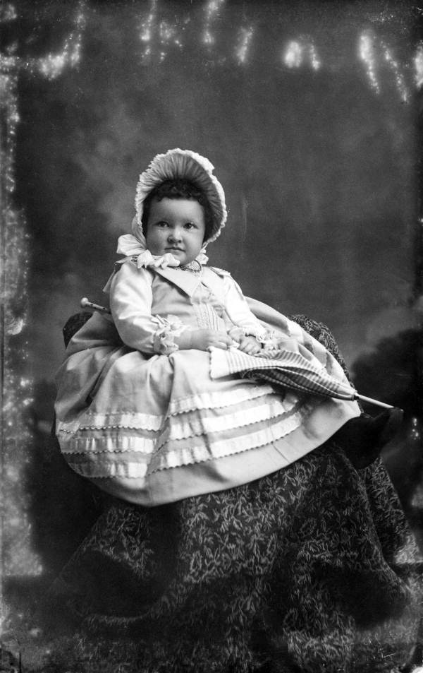 Miss Webster holding a parasol.