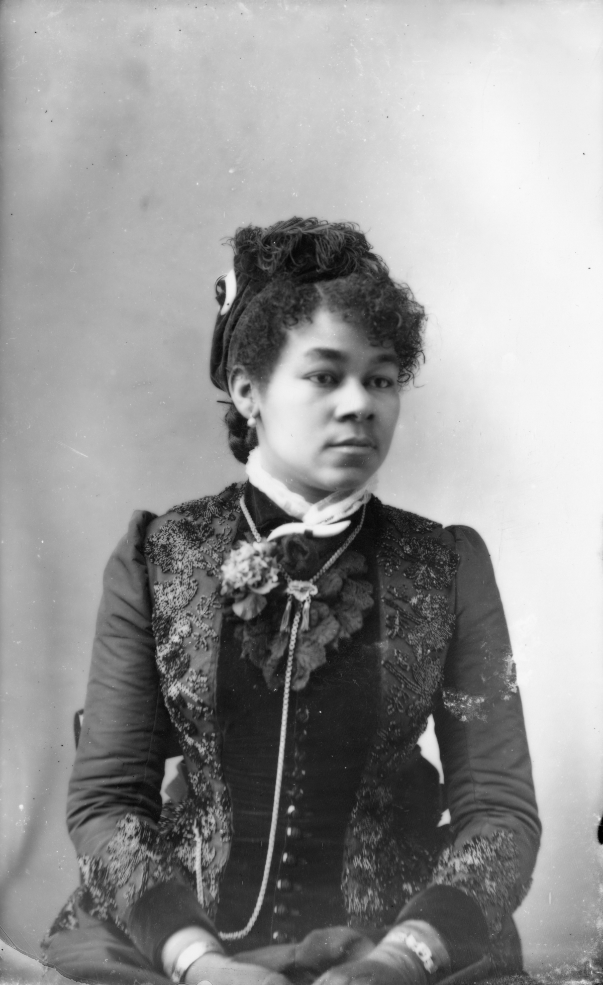Rosebud Denham wearing a hat with feather.