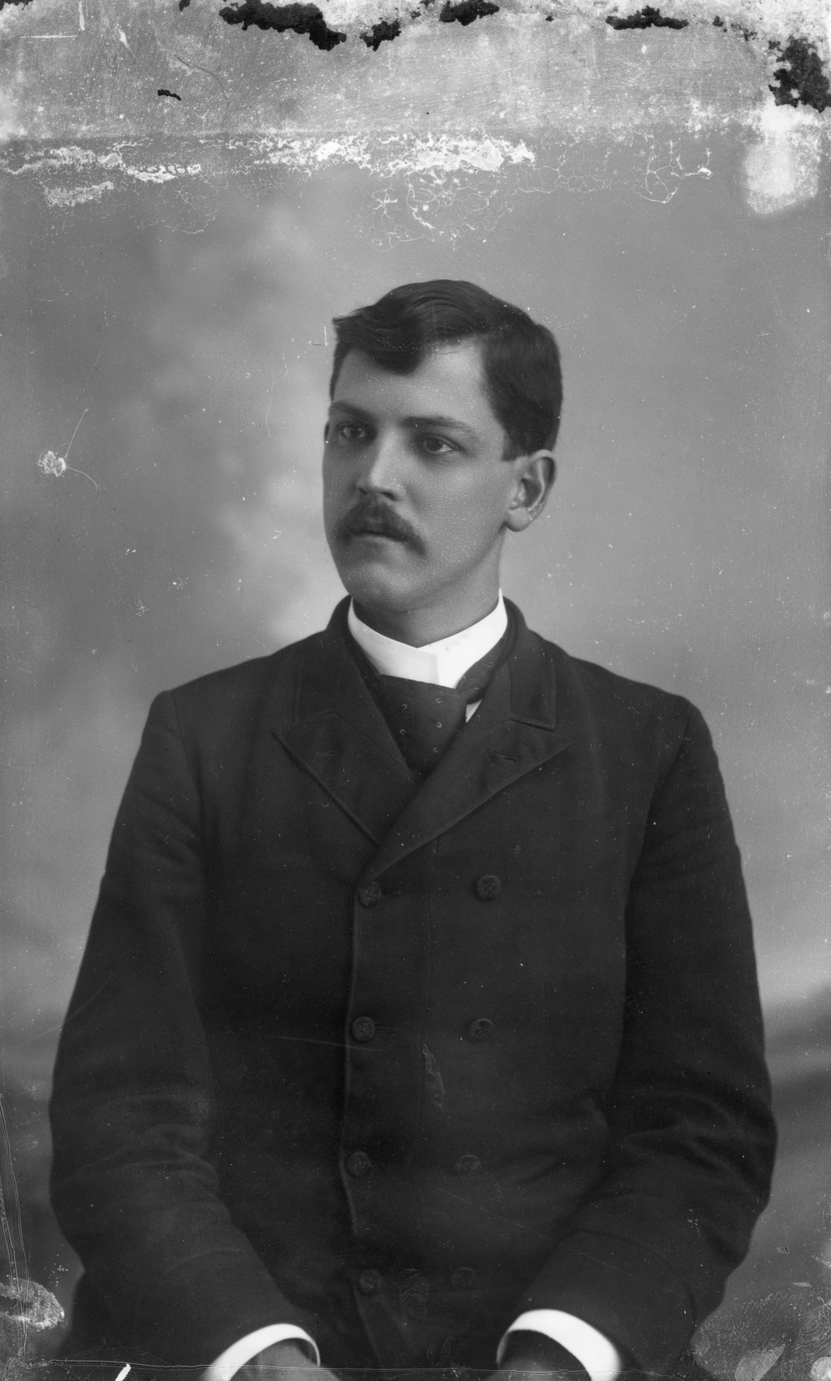 Unidentified man sitting for a portrait.