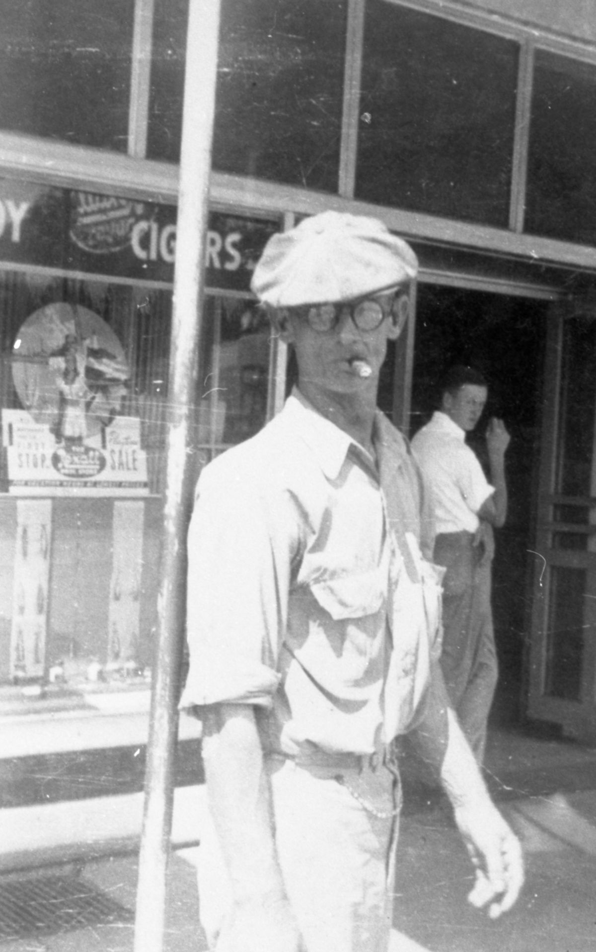 Schley J. Warren Sr. smoking a cigar in front of a drugstore - Madison County, Florida