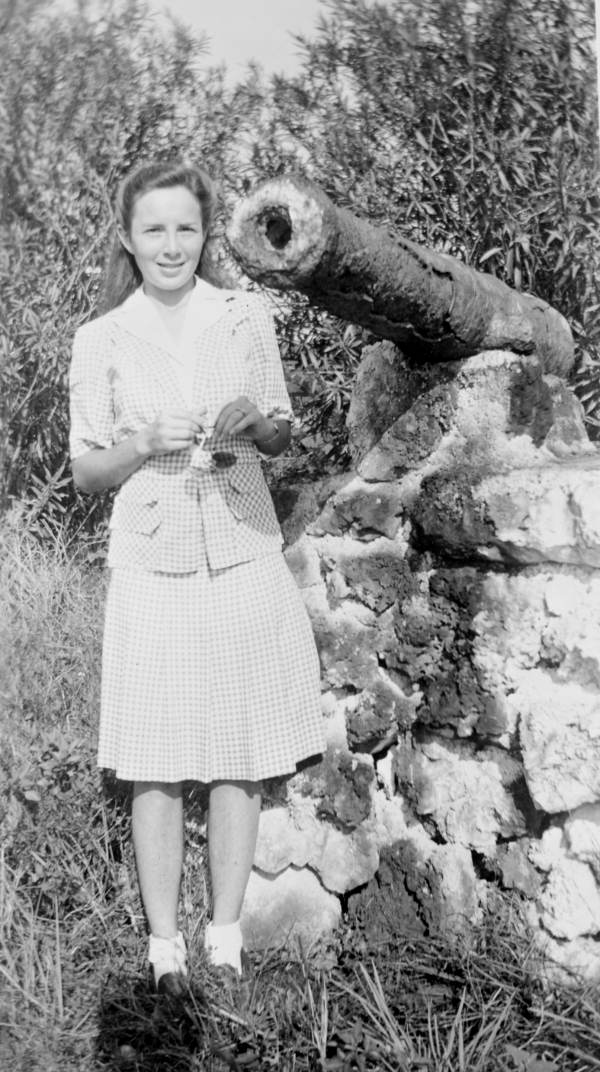 Art McKee's wife, Gay, standing next to a cannon retrieved from a shipwreck