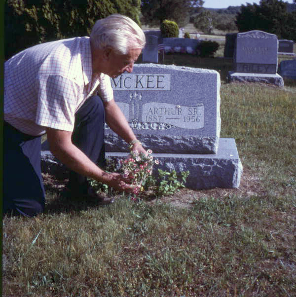 Art McKee placing flowers at his father's grave