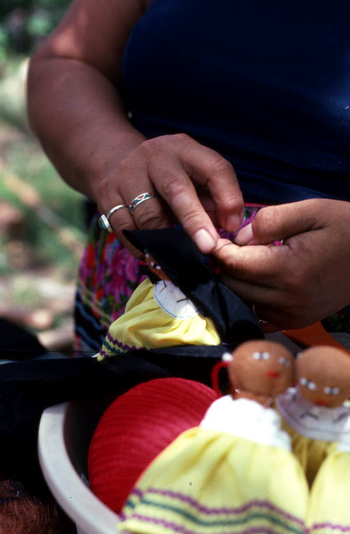 Mary Billie sewing hair on the Seminole doll she is making: Big Cypress Seminole Indian Reservation, Florida