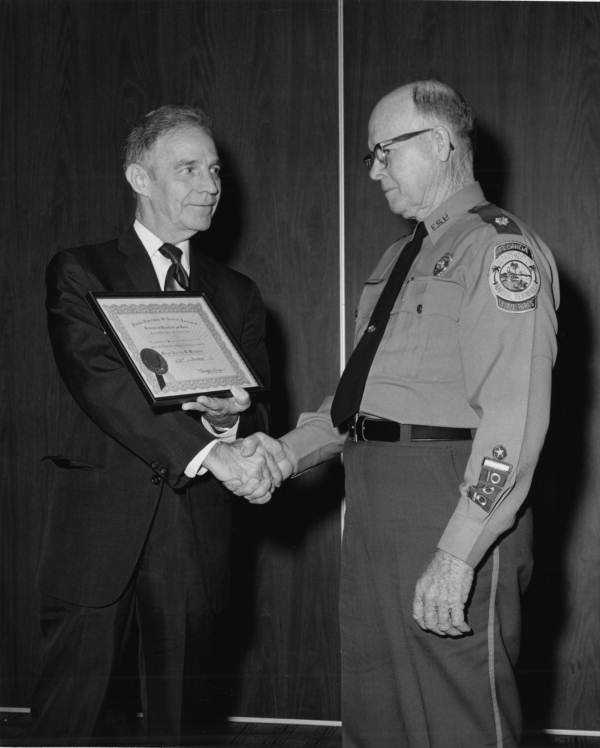 Florida Park Service park ranger and manager Carlos Maxwell receiving service merit award from DNR upon his retirement - Tallahassee, Florida.