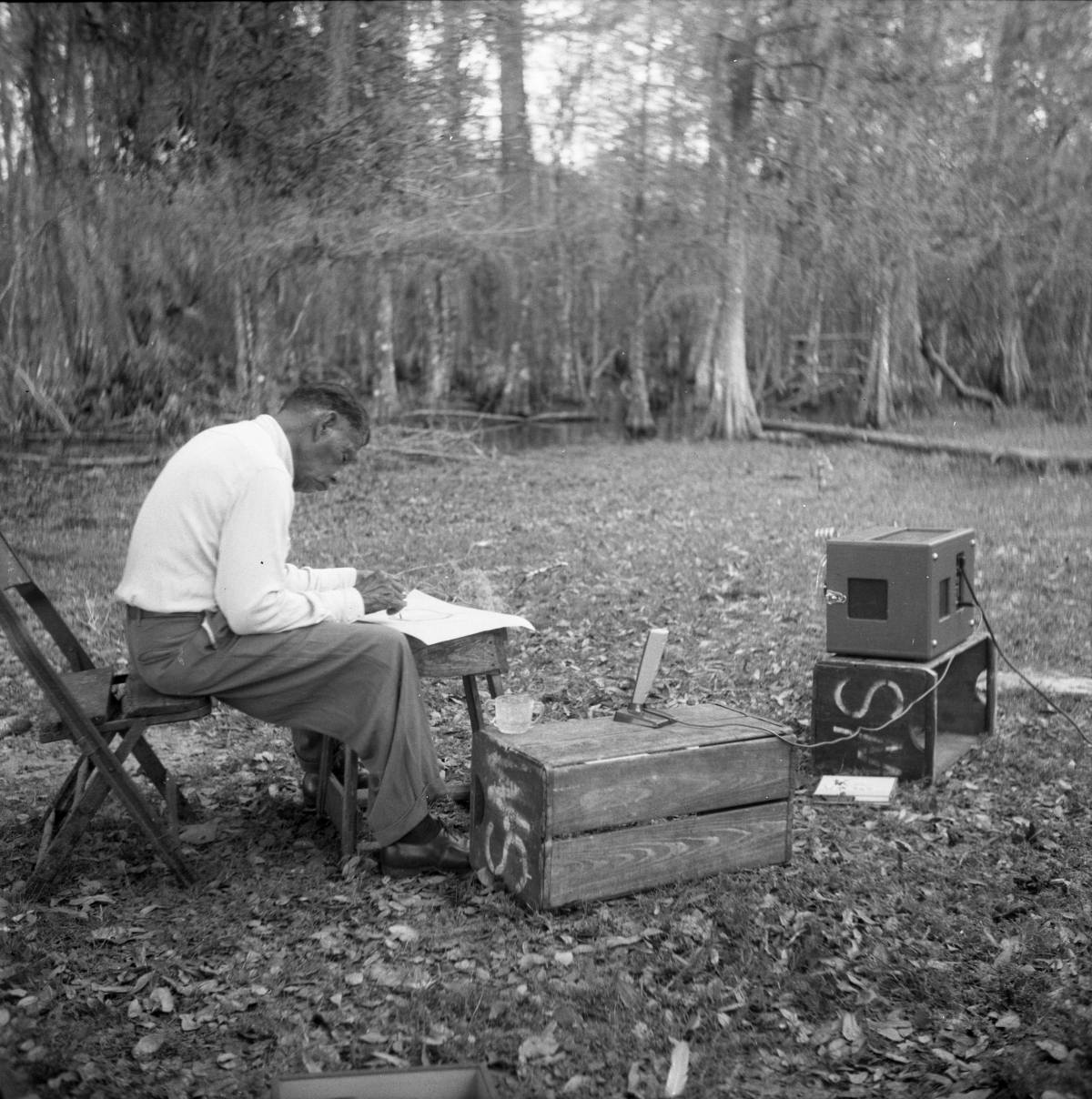 Seminole Indian Josie Billie sitting in chair near a recorder