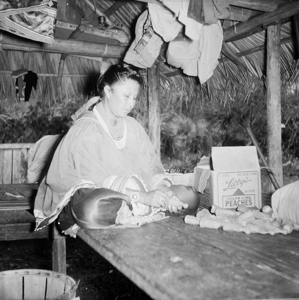 Seminole woman making dolls