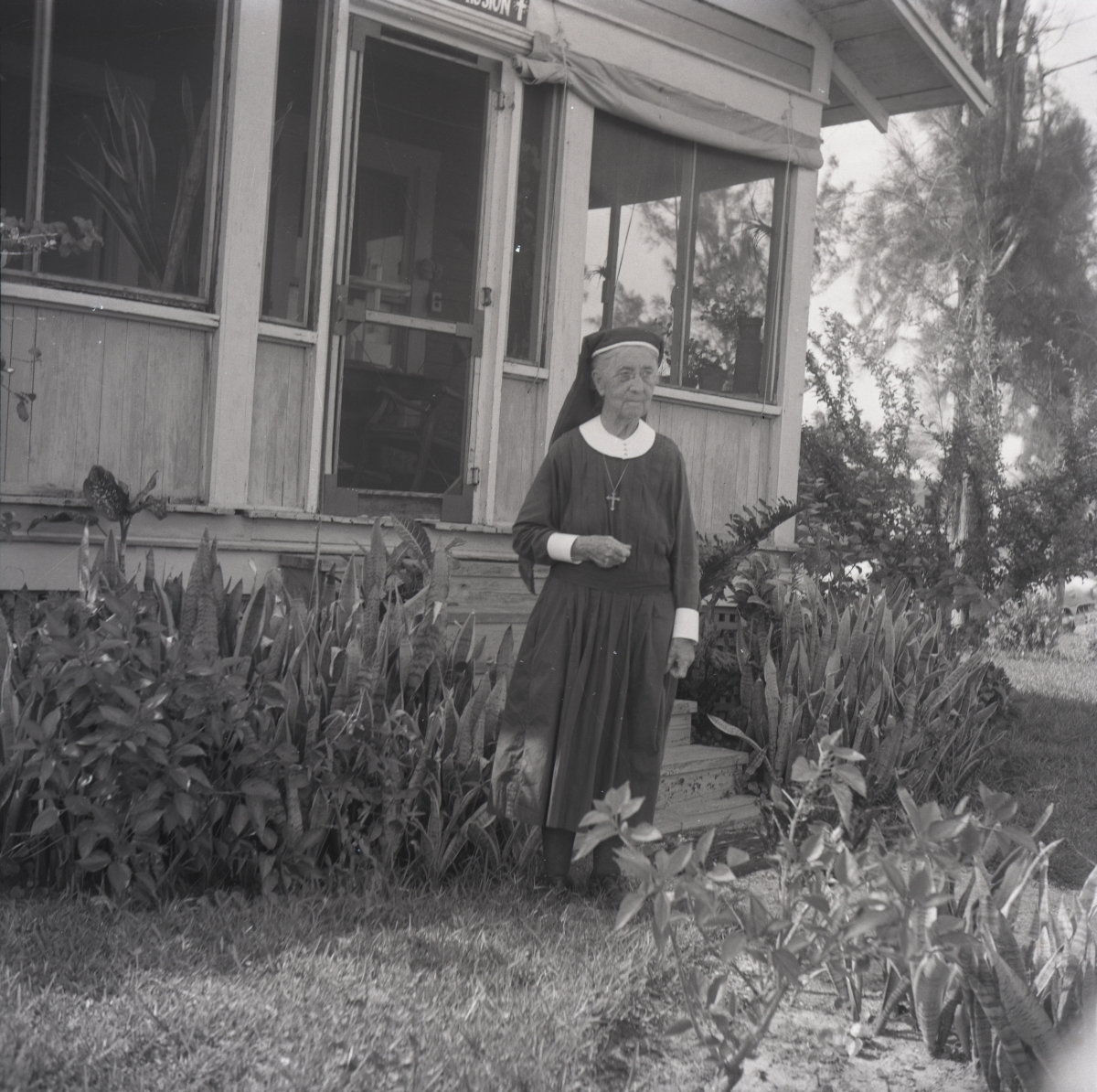 Deaconess Harriet Bedell standing in front of the Glade Cross Mission