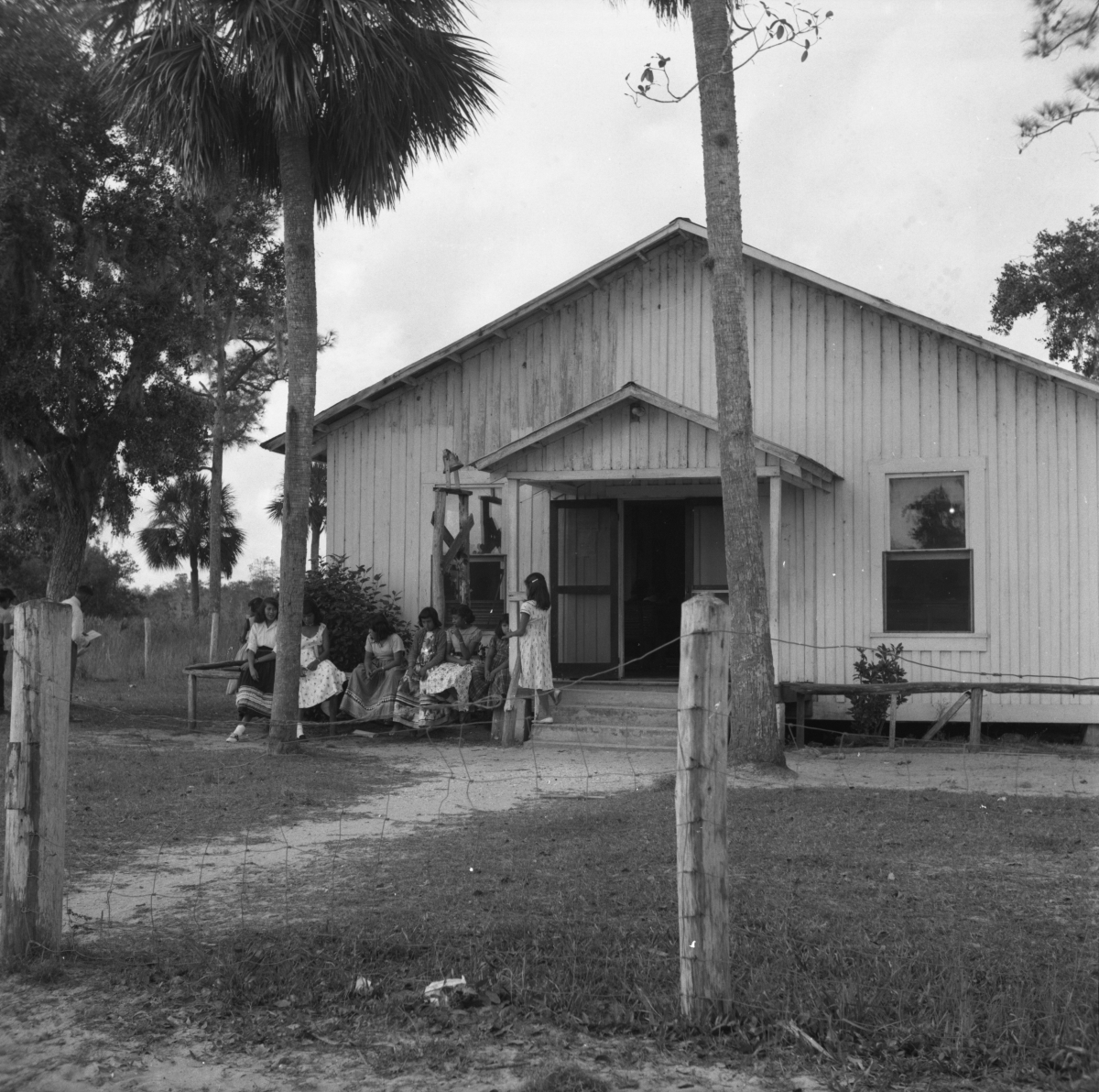 Seminole girls sitting in front of Baptist Church