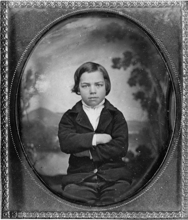 Portrait of Richard Call Long sitting with arms folded.
