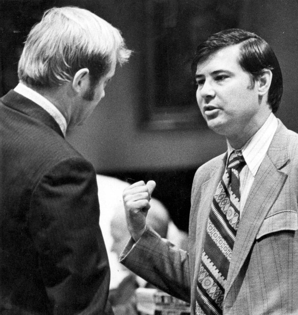 Florida legislators Bob Graham and Joel K. Gustafson conversing in the house chamber