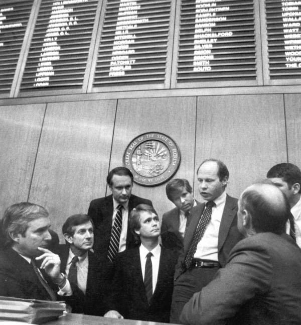 Representatives conferring on the floor of the Florida House