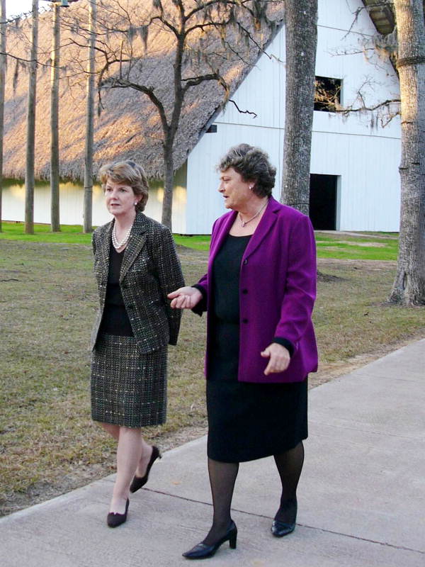 Secretary of State Glenda Hood and House Tourism Committee chairperson Nancy Detert walking in front of historic San Luis Mission church building.