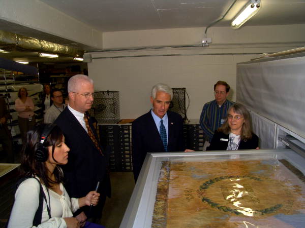 Chief of the Bureau of Historical Museums Jeana Brunson showing Civil War flag to SOS Kurt Browning and Gov. Charlie Crist.