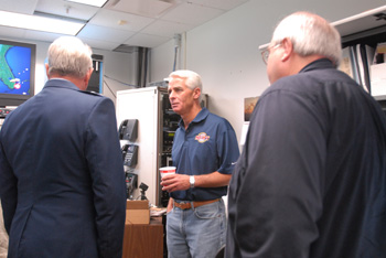 Governor Charlie Crist, center, speaking with Florida National Guard General Douglas Burnett during Tropical Storm Fay as Florida Division of Emergency Management director W. Craig Fugate looks on.