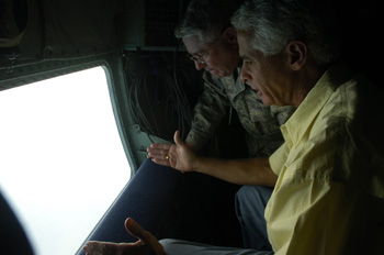 Governor Charlie Crist with Florida National Guard Adjutant General Douglas Burnett looking out from the U.S. Air Force turboprop airplane used to transport them during Tropical Storm Fay.