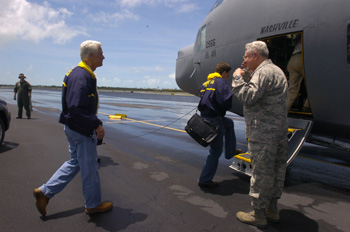 Governor Charlie Crist, left, boarding U.S. Air Force turboprop airplane during Tropical Storm Fay.
