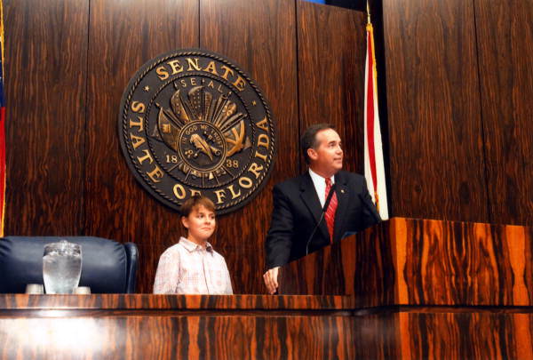 10-year-old Ryan Detert standing with Senate President Jeff Atwater.