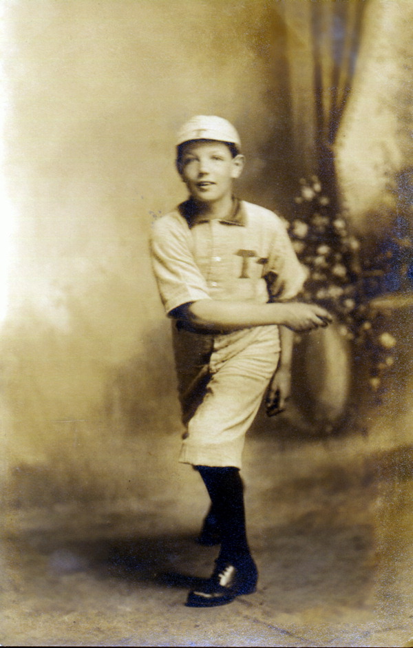 Boy posing in baseball uniform