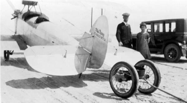 Man and child standing next to the "Miss Nancy" at Saint Augustine Beach, Florida.