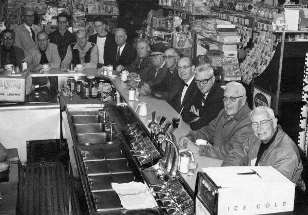 Group portrait of Lion Club members in a Lake Wales drug store.