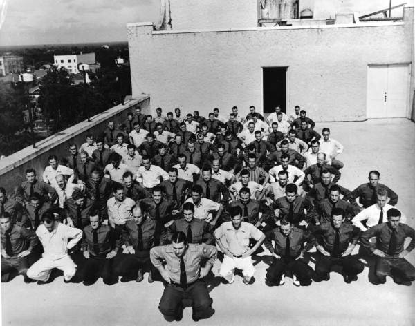 1941 recruit class of the Florida Highway Patrol performing calisthenics on top of the New Florida Hotel in Lakeland, Florida.