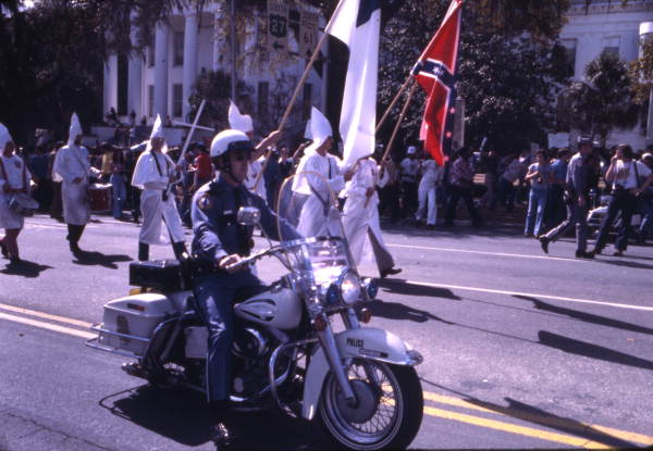 KKK members being escorted by motorcycle police during rally on South Monroe Street in Tallahassee, Florida.