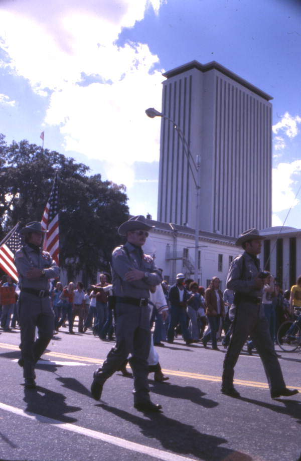 View showing KKK members marching north on South Monroe Street during a rally in front of the Capitol building - Tallahassee, Florida.