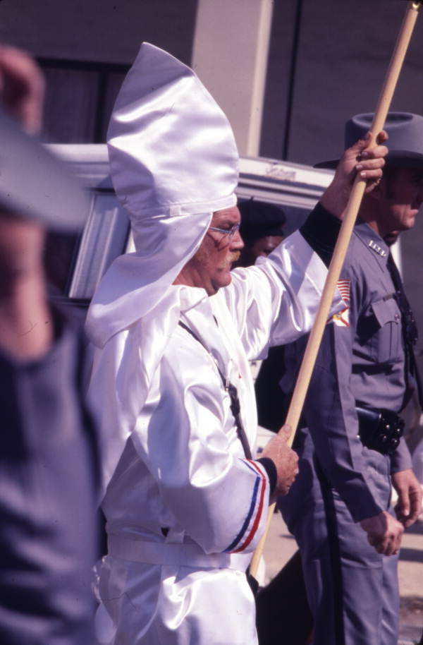 View showing a KKK member marching in a rally on South Monroe Street in Tallahassee, Florida.