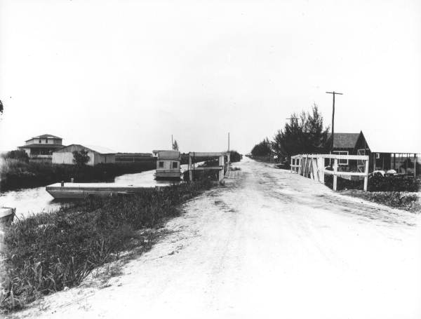 View looking along road next to an Everglades Drainage District canal.
