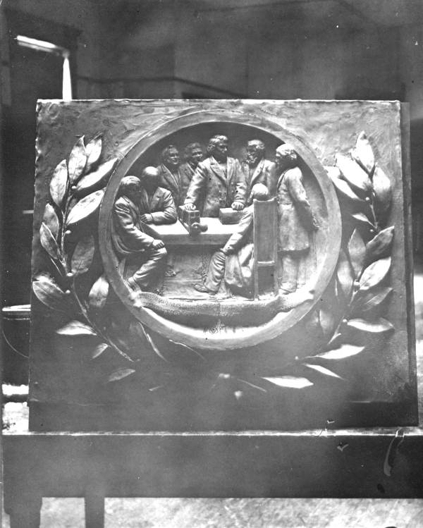 Wax casting of a frieze from the Gorrie Memorial showing his ice machine invention.