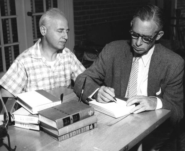 Philip Wylie autographs a book for Dr. Louis Shores