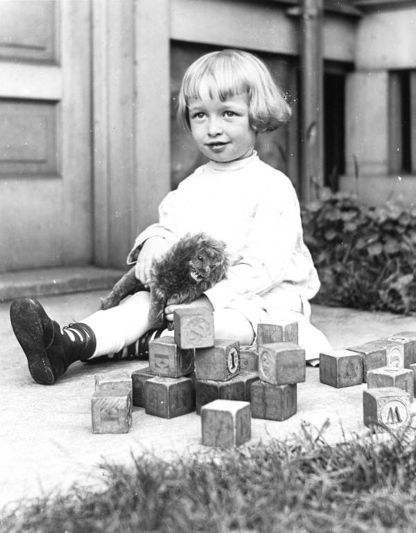 Boy with toy lion and blocks