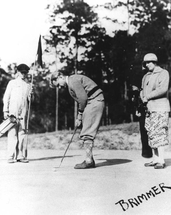 Couple with caddy on the course